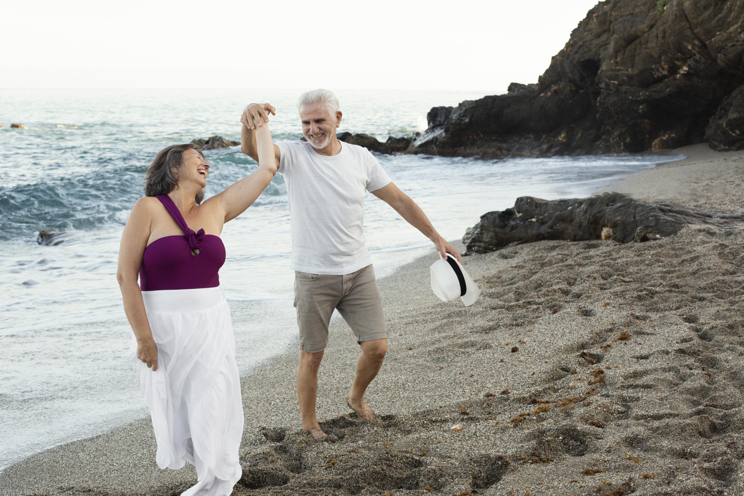senior loving couple spending time together beach