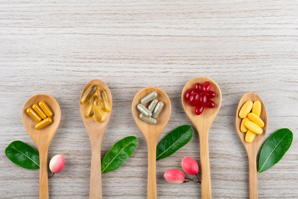 Natural vitamins and herbal supplements on wood — alternative medicine and nutrition over 50