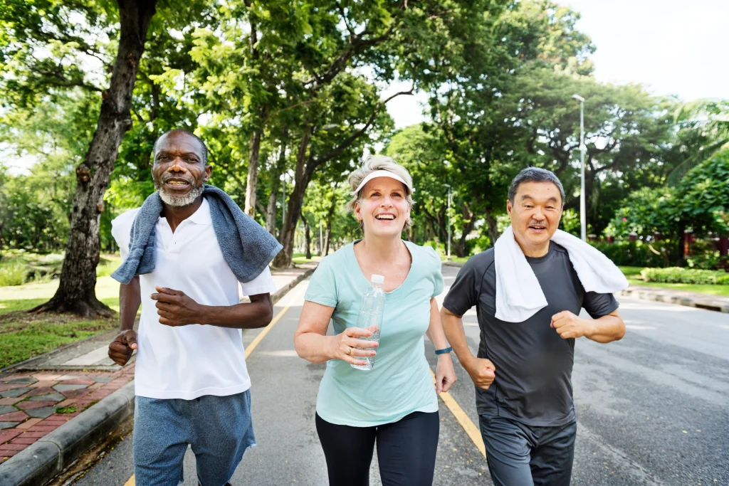 Group of senior friends jogging together in the park — staying active and social over 50