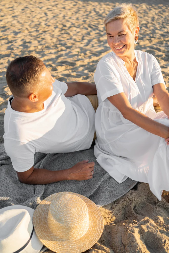 Couple relaxing on the beach — enjoying life and staying well over 50