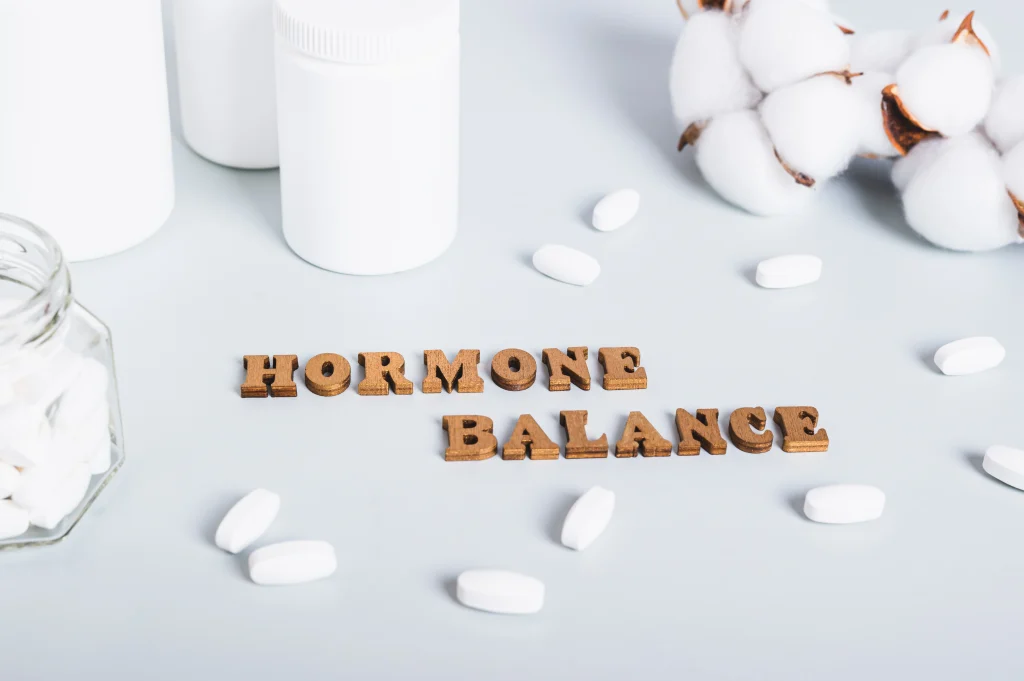 hormonal-balance-concept-pills-bottles-text-blue-background